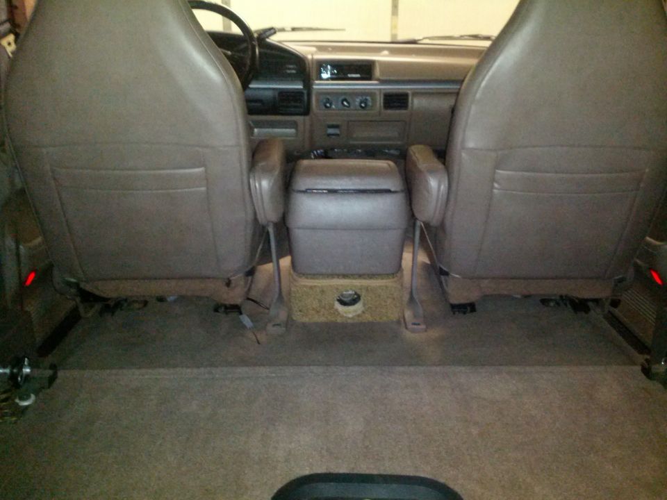 Tan interior of a 1992 Ford Bronco with front seats, center console, and cargo area visible