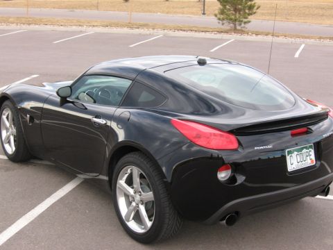 1995 Ford Bronco - Black Pontiac Solstice coupe with a Colorado license plate.