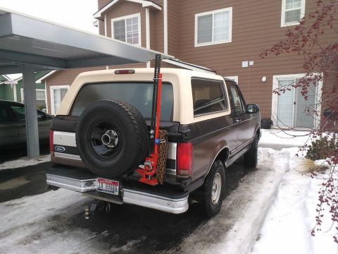 1992 Ford Bronco - A 1992 Ford Bronco is parked in a snowy driveway with a Hi-Lift jack attached to the rear.