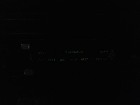 1979 Ford Bronco - Interior climate control panel with various functions labeled in white text against a dark background.