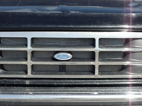 1993 Ford Bronco - The chrome grille features horizontal bars and a central Ford emblem.