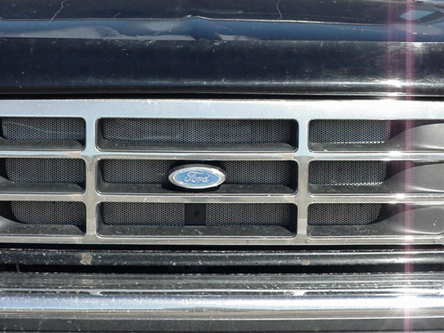 Close-up of a 1992 Ford truck grille with a Ford oval badge