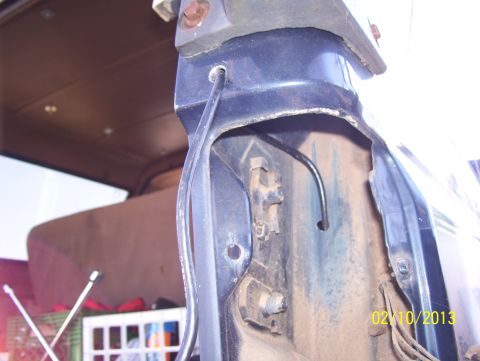 1990 Ford Bronco - Detail of a vehicle's fender mounting bracket and interior, with a date stamp of 02/10/2013.