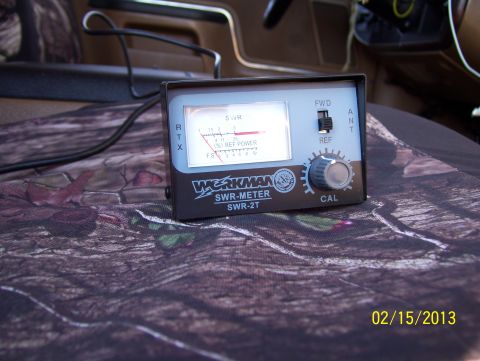 1990 Ford Bronco - A Workman SWR meter is placed on a camouflage seat cover inside a vehicle.