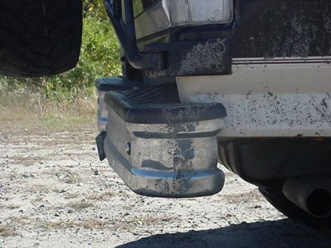 1993 Ford Bronco - The rear bumper and spare tire of a 1992 Ford Bronco are visible, showing significant wear and tear.