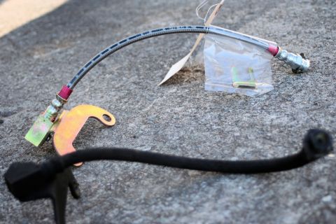 1976 Ford Ranchero - A brake hose and mounting bracket are shown on a concrete surface.