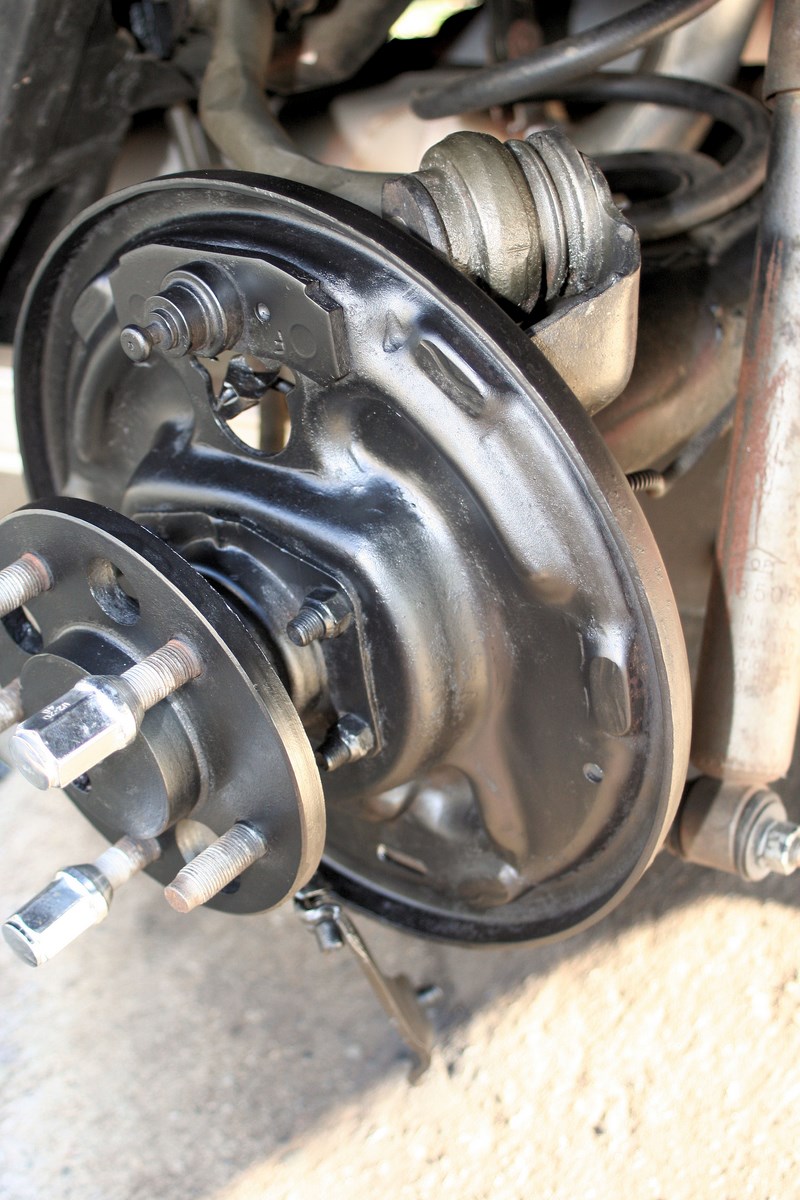 Close-up of a vehicle's rear drum brake assembly with the wheel hub visible