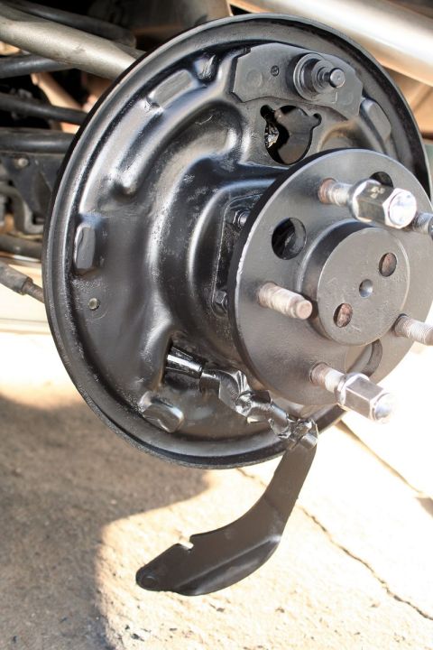 1976 Ford Ranchero - Close-up of a vehicle's rear drum brake assembly, showing the brake shoes and backing plate.