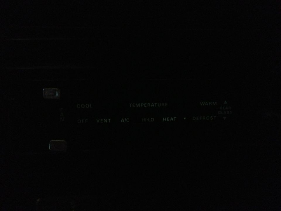Climate control panel with buttons for fan, temperature, cool, heat, A/C, defrost, and rear glass