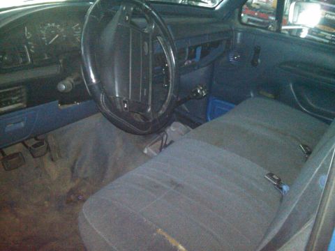 1993 Ford Bronco - The interior of a 1993 Ford Bronco shows blue seats and dashboard details.