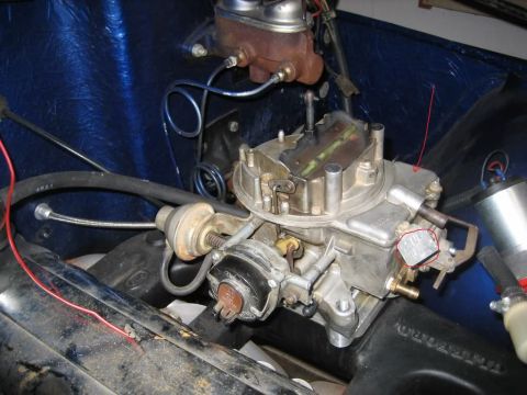 1982 Jeep Wagoneer - Close-up view of engine components, including a carburetor and brake master cylinder.