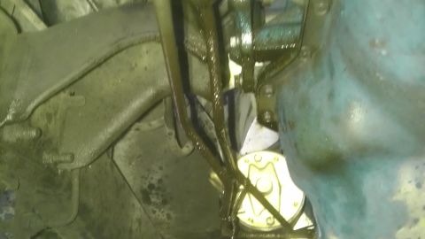1982 Jeep Wagoneer - Underside view of a vehicle showing oil leaks and various mechanical components, suggesting maintenance or repair needs.
