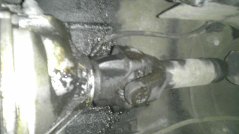 1982 Jeep Wagoneer - Underside view of a vehicle's driveshaft universal joint, covered in grease.