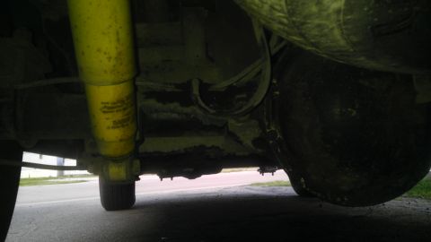 1982 Jeep Wagoneer - Close-up of the rear axle and suspension system, with visible yellow shock absorber and differential.