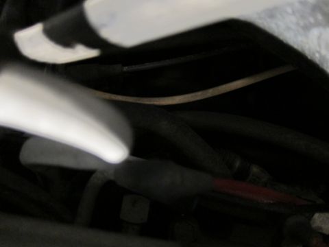 1991 Ford LTD Crown Victoria - Close-up view of a vehicle's engine bay wiring harness, showing various cables and connectors.