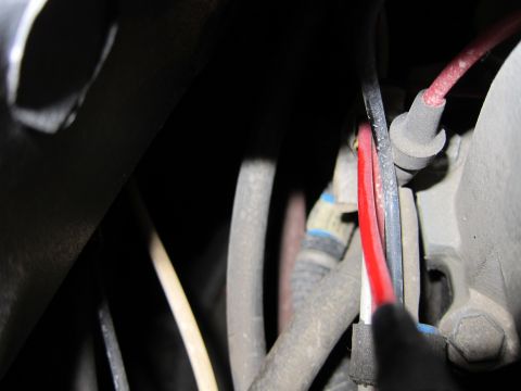 1991 Ford LTD Crown Victoria - Detail of wiring harness and spark plug wire in an engine compartment.