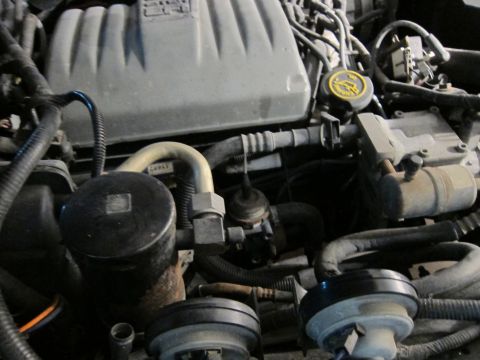 1991 Ford LTD Crown Victoria - Close-up view of an engine bay, showing various components and hoses.