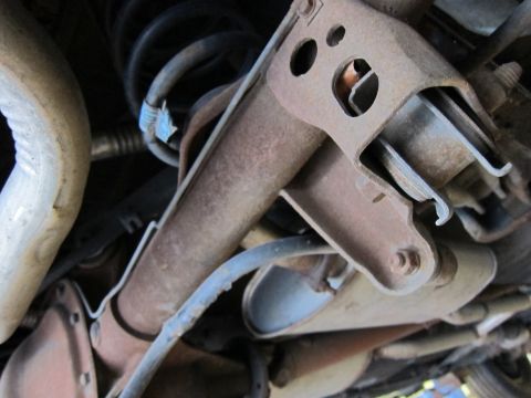 1991 Ford LTD Crown Victoria - Close-up view of the rear suspension and exhaust system of a 1991 Ford Crown Victoria LTD.