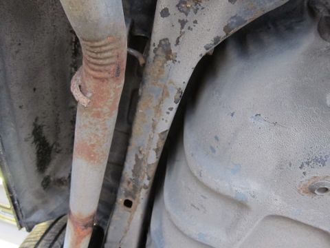 1991 Ford LTD Crown Victoria - Close-up of the undercarriage, focusing on the exhaust system and structural elements.