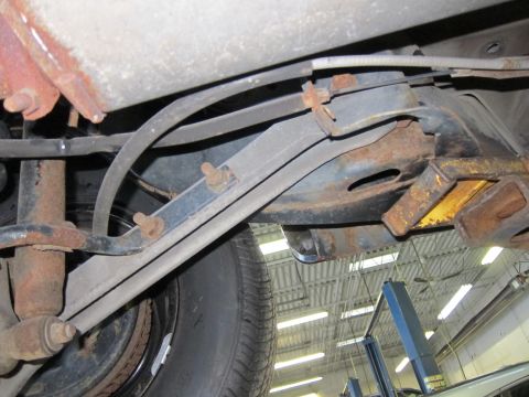 1991 Ford LTD Crown Victoria - Underbody view shows suspension components and a tire, with a vehicle lift in the background.