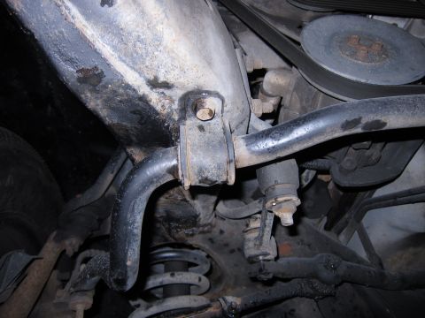 1991 Ford LTD Crown Victoria - Underside view of front suspension components, showing sway bar, springs, and steering linkage.