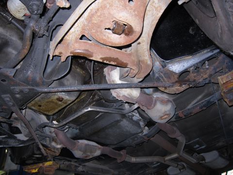 1991 Ford LTD Crown Victoria - Undercarriage view of a 1991 Ford Crown Victoria LTD, revealing its suspension and exhaust system components.