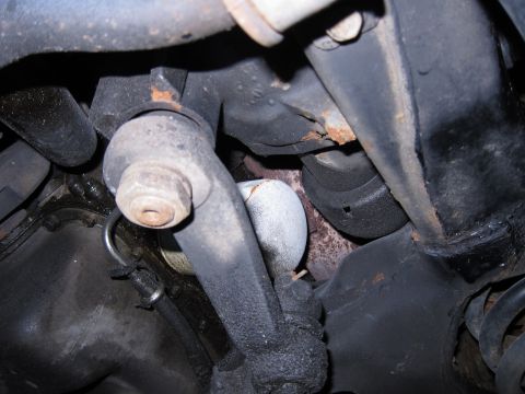 1991 Ford LTD Crown Victoria - Underside view of a vehicle's suspension components, including an oil filter.