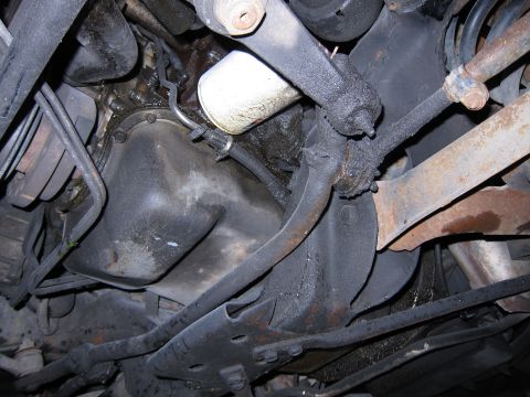 1991 Ford LTD Crown Victoria - Underside view of a vehicle's engine, highlighting the oil pan and filter with visible grease and grime.
