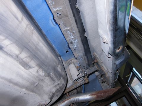 1991 Ford LTD Crown Victoria - Close-up view of the undercarriage of a vehicle, revealing structural components and exhaust system details.