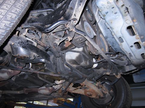 1991 Ford LTD Crown Victoria - Undercarriage of a 1991 Ford Crown Victoria LTD, revealing suspension and engine bay details.