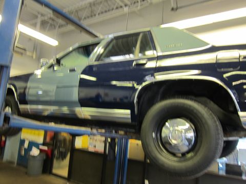 1991 Ford LTD Crown Victoria - This Ford Crown Victoria is on a vehicle lift in what appears to be a repair shop.