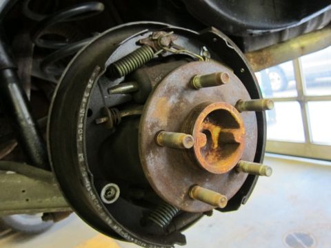 1991 Ford LTD Crown Victoria - Rear drum brake assembly showing wear and rust on components.