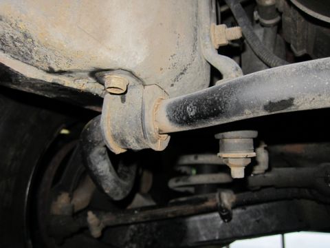 1991 Ford LTD Crown Victoria - Undercarriage view showing suspension components, including a sway bar and coil spring.
