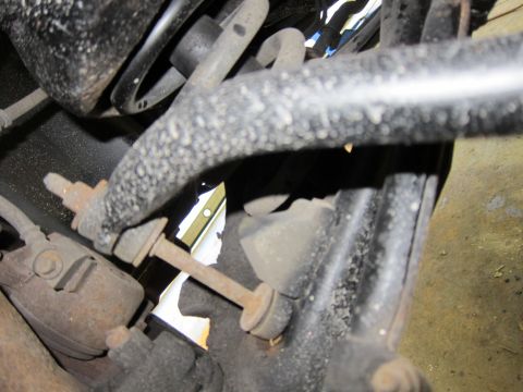 1991 Ford LTD Crown Victoria - Underside view of a vehicle's suspension system, showing various metal components and rubber bushings.
