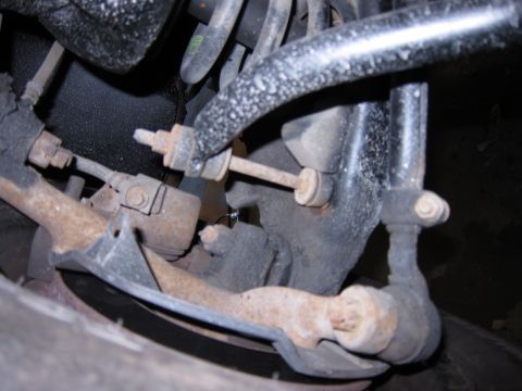 1991 Ford LTD Crown Victoria - Rusty suspension parts, possibly from a Ford Crown Victoria, are visible in this close-up shot.