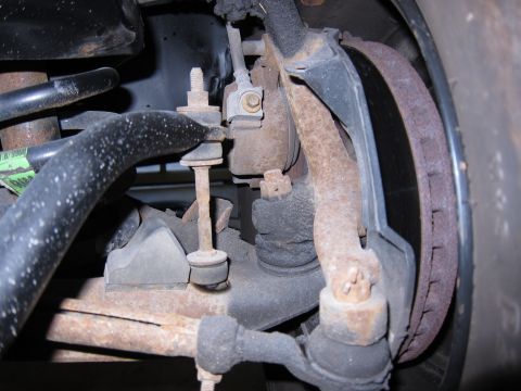 1991 Ford LTD Crown Victoria - Close-up view of the front suspension and brake assembly of a 1991 Ford Crown Victoria LTD.
