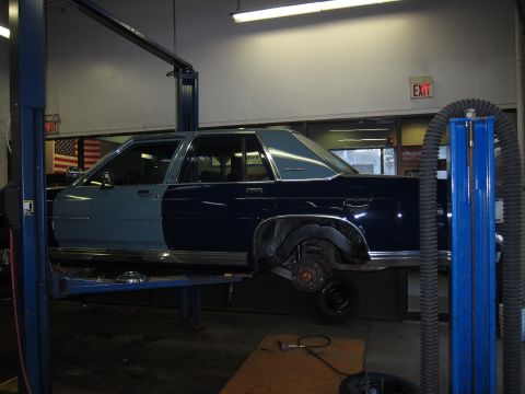 1991 Ford LTD Crown Victoria - This 1991 Ford Crown Victoria is on a lift in a garage, showing its two-tone paint job.