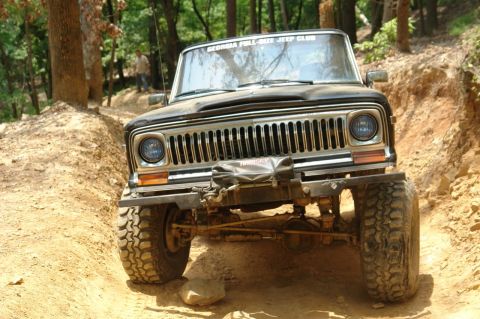 1982 Jeep Wagoneer - This 1982 Jeep Wagoneer navigates an off-road trail, displaying a "Georgia Full-Size Jeep Club" sticker on its windshield.