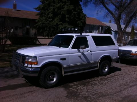 1994 Ford Bronco - White 1994 Ford Bronco parked on a residential street.