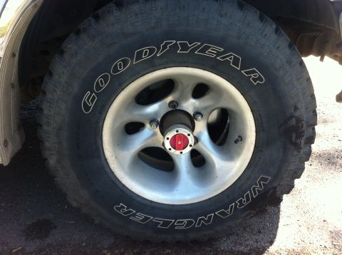 1994 Ford Bronco - A close-up view of a tire and wheel assembly, showing the Goodyear Wrangler branding.