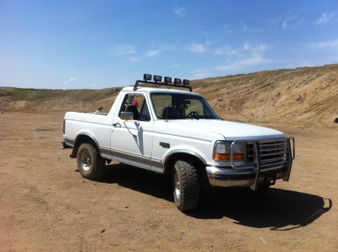 1994 Ford Bronco - This 1994 Ford Bronco is shown in a three-quarter front view, equipped with a roof-mounted light bar and a front brush guard.