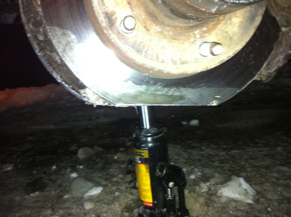 Vehicle brake rotor supported by a hydraulic jack on the ground