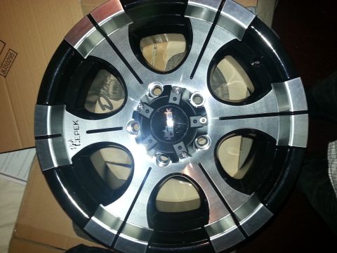 1994 Ford Bronco - A single aftermarket wheel with a multi-spoke design and a black and silver finish is shown.