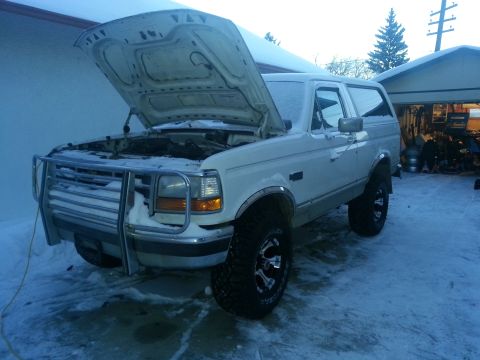 1994 Ford Bronco - White 1994 Ford Bronco with hood open, parked in a snowy area.