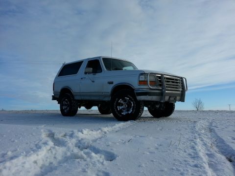 1994 Ford Bronco - This 1994 Ford Bronco is captured in a snowy environment, its robust build and brush guard.