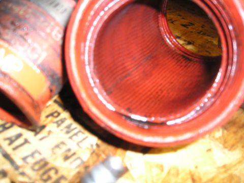 1997 Ford F-250 - Close-up of a red turbo hose, with some text visible on the packaging underneath.