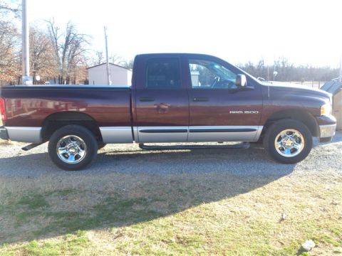 2004 Dodge 1500 - Maroon 2004 Dodge Ram 1500 pickup truck shown from the side, silver lower body trim and chrome wheels.