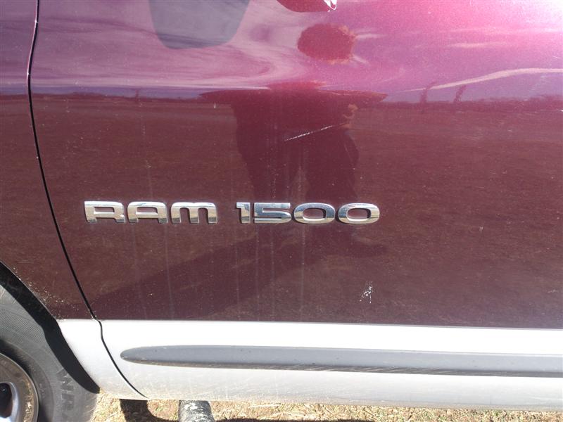 RAM 1500 badge on maroon truck side
