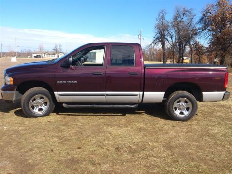 2004 Dodge 1500 - Side view of a maroon 2004 Dodge Ram 1500 pickup truck with silver lower body panels.