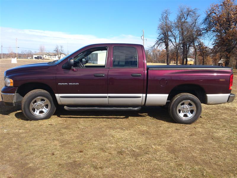 Maroon 2004 Dodge Ram 1500 pickup truck, side view. Two-tone paint with silver lower body